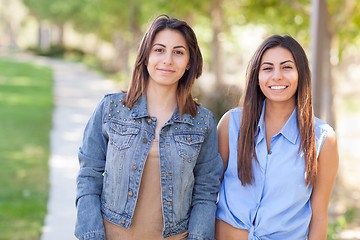 Image showing Two Beautiful Ethnic Twin Sisters Portrait Outdoors.