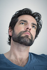 Image showing bearded man looking upwards