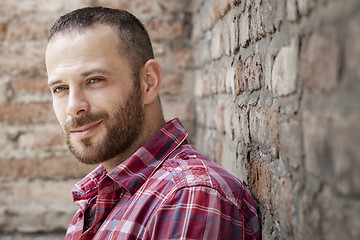 Image showing bearded man at the brick wall