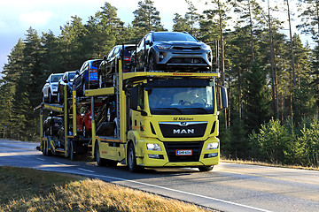 Image showing Yellow MAN TGS 18.420 Car Carrier Hauls New Cars
