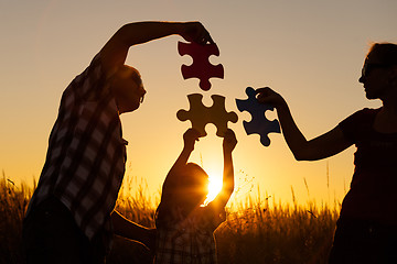 Image showing Happy family playing at the park at the sunset time.