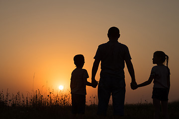 Image showing Father and children playing in the park at the sunset time.