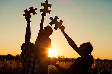 Image showing Happy family playing at the park at the sunset time.