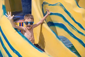 Image showing happy child playing on the swimming pool at the day time.