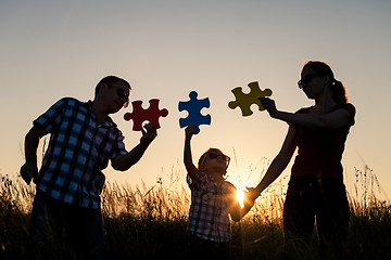 Image showing Happy family playing at the park at the sunset time.