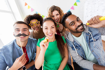 Image showing happy friends or team having fun at office party