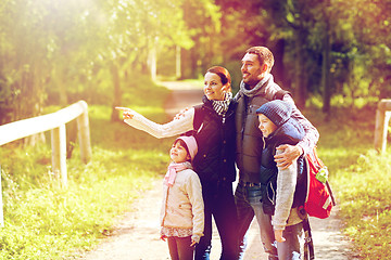 Image showing happy family with backpacks hiking