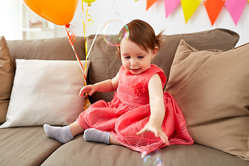 Image showing baby girl with soap bubbles on birthday party