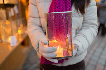 Image showing woman with candle in lantern at christmas market