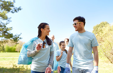 Image showing volunteers with garbage bags talking outdoors