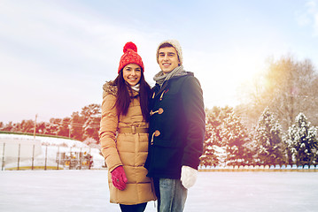 Image showing happy couple ice skating on rink outdoors