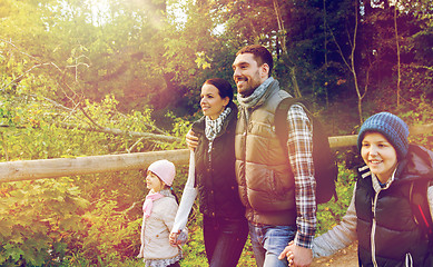 Image showing happy family with backpacks hiking