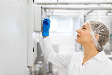 Image showing woman programming computer at ice cream factory