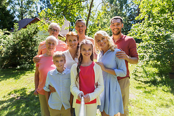 Image showing happy family taking selfie in summer garden