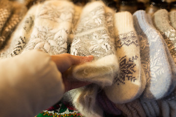 Image showing woman buying woolen mittens at christmas market