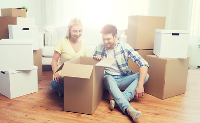 Image showing smiling couple with big boxes moving to new home