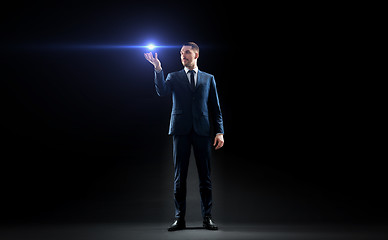 Image showing businessman with laser light over black