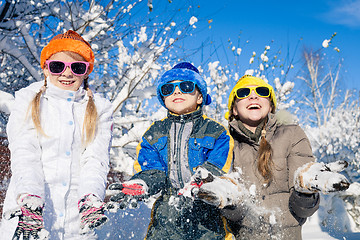 Image showing Happy little children playing  in winter snow day.