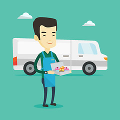 Image showing Delivery man holding a box of cakes.