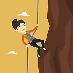 Image showing Business woman climbing on the mountain.