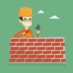 Image showing Bricklayer working with spatula and brick.