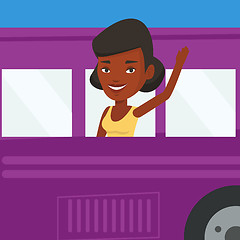 Image showing Woman waving hand from bus window.