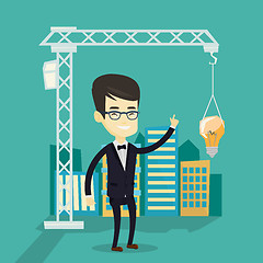 Image showing Man pointing at idea bulb hanging on crane.