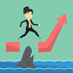 Image showing Business woman jumping over ocean with shark.