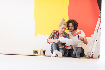 Image showing Happy young couple relaxing after painting