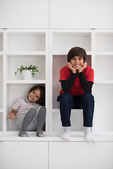 Image showing young boys posing on a shelf