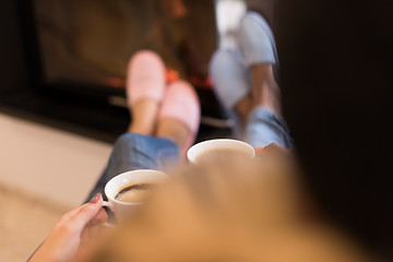 Image showing Young multiethnic couple  in front of fireplace