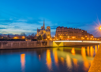 Image showing Notre Dame Cathedral with Paris cityscape at dus