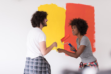 Image showing multiethnic couple painting interior wall