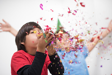 Image showing kids  blowing confetti