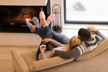 Image showing Young couple  in front of fireplace