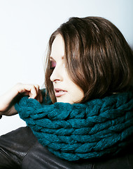 Image showing young pretty real woman in sweater and scarf all over her face s