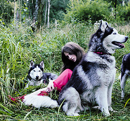 Image showing woman in red dress with tree wolfs, forest, husky dogs mystery p