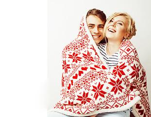 Image showing young pretty teenage couple at Christmas time warming in red dec