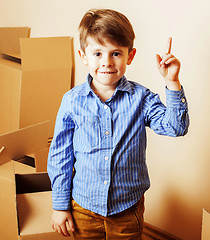 Image showing little cute boy in empty room, remoove to new house. home alone,