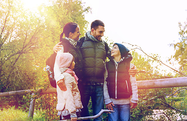 Image showing happy family with backpacks hiking