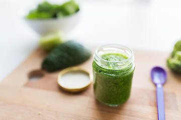 Image showing jar with puree or baby food on wooden board