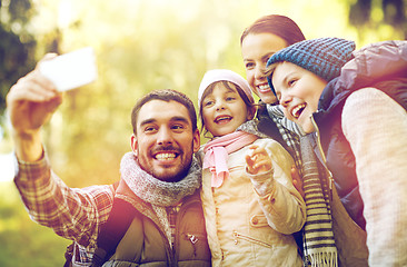 Image showing family taking selfie with smartphone outdoors