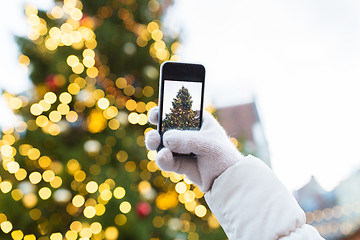 Image showing hands with smartphone photographing christmas tree