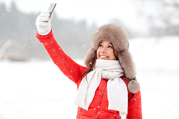 Image showing happy woman taking selfie outdoors in winter