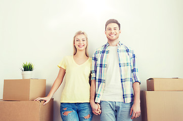 Image showing smiling couple with big boxes moving to new home