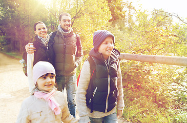 Image showing happy family with backpacks hiking