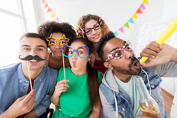 Image showing happy friends or team having fun at office party