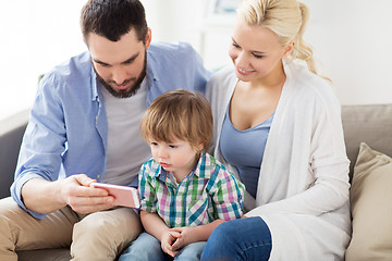 Image showing happy family with smartphone at home