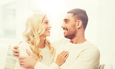 Image showing happy couple hugging on sofa at home