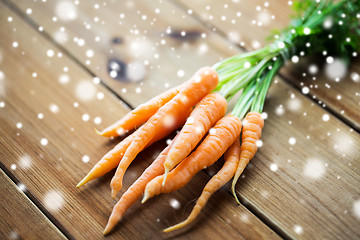 Image showing close up of carrot bunch on wooden table